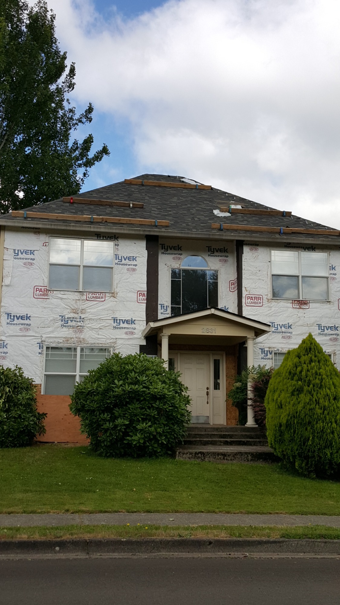 House under renovation with shrubbery